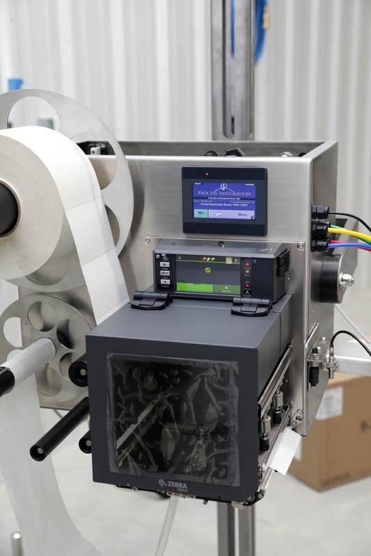 A Process Integration, Inc. printer applicator labelling on a production line