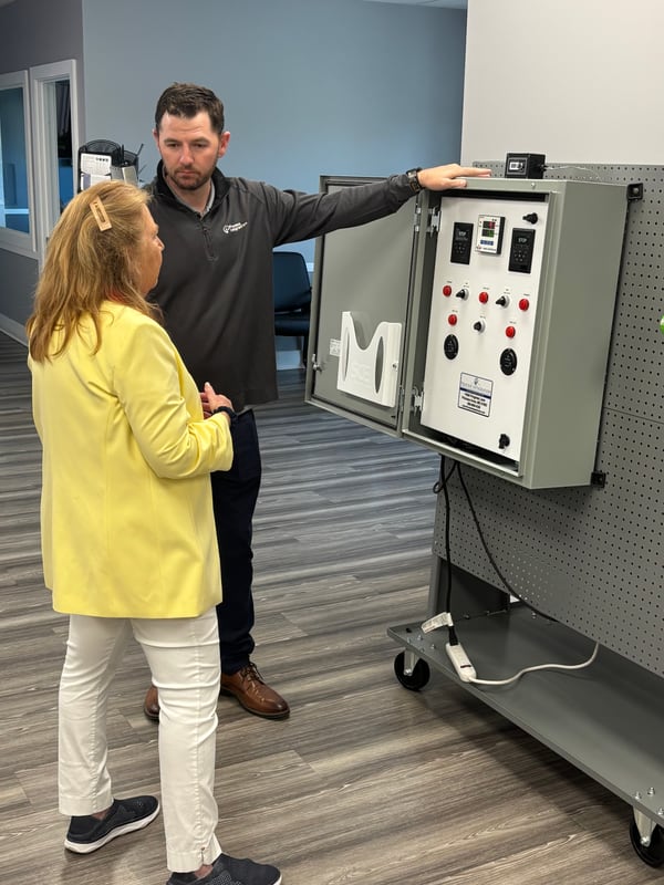 A Process Integration, Inc. engineer showing a Shorite Controls control panel to a visitor