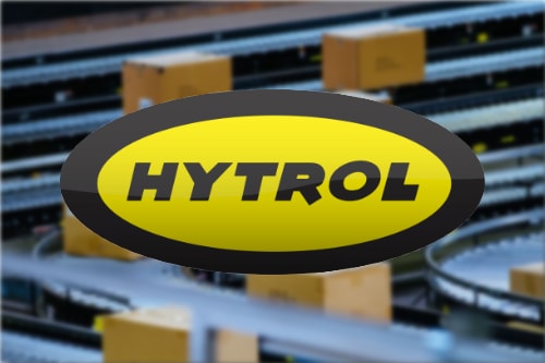 The Hytrol logo over cartons moving along a live roller conveyor