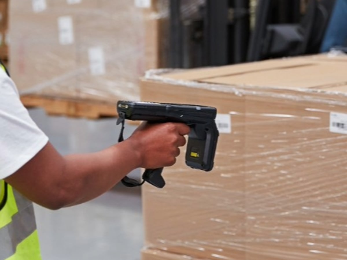 A worker reading tagged cartons with a handheld RFID gun