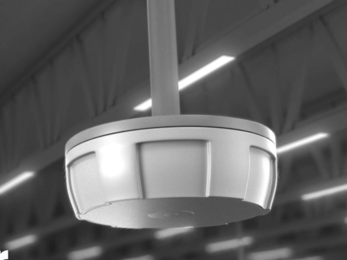 A ceiling-mounted overhead RFID reader in a warehouse