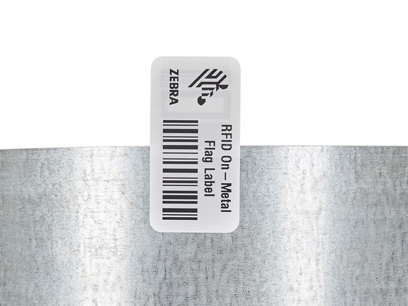 A Zebra on-metal flag label fixed to a metal cylinder
