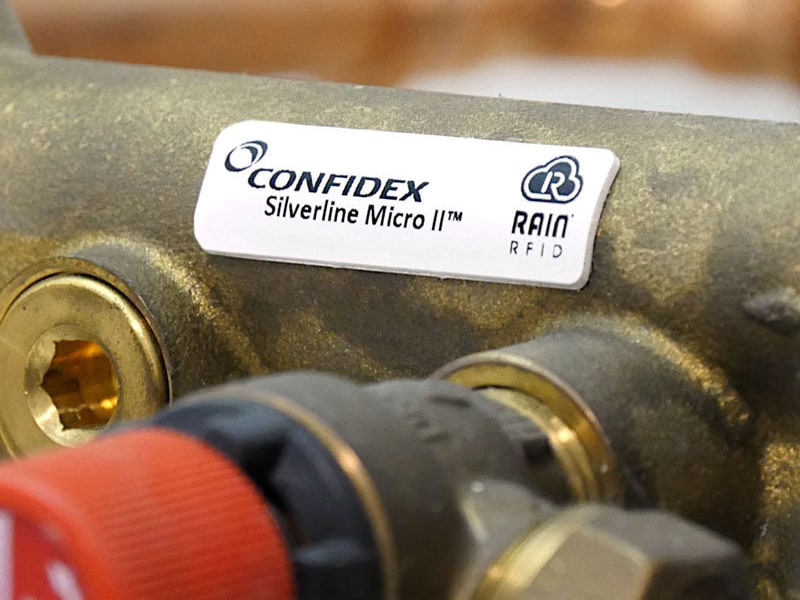 A Confidex Silverline Micro II tag fitted to a brass valve