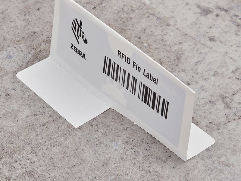 A Zebra RFID on-metal flag label standing on a concrete surface