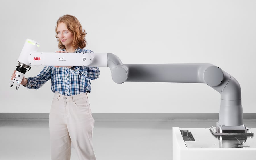 An operator hand-guiding an ABB GoFa collaborative robot by its arm