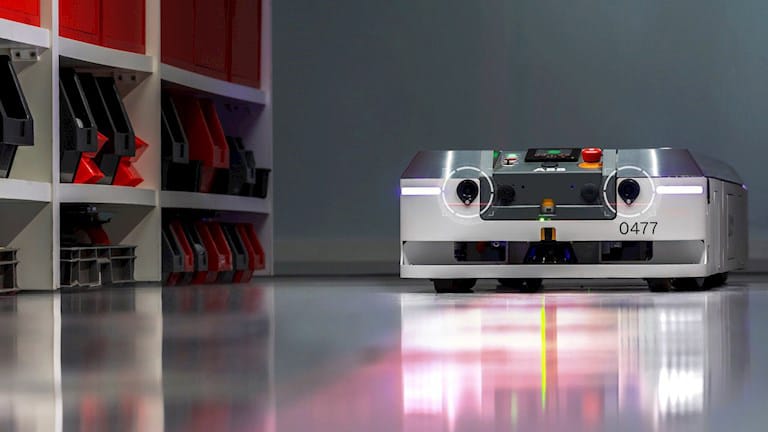 An autonomous mobile robot moving stock through a warehouse