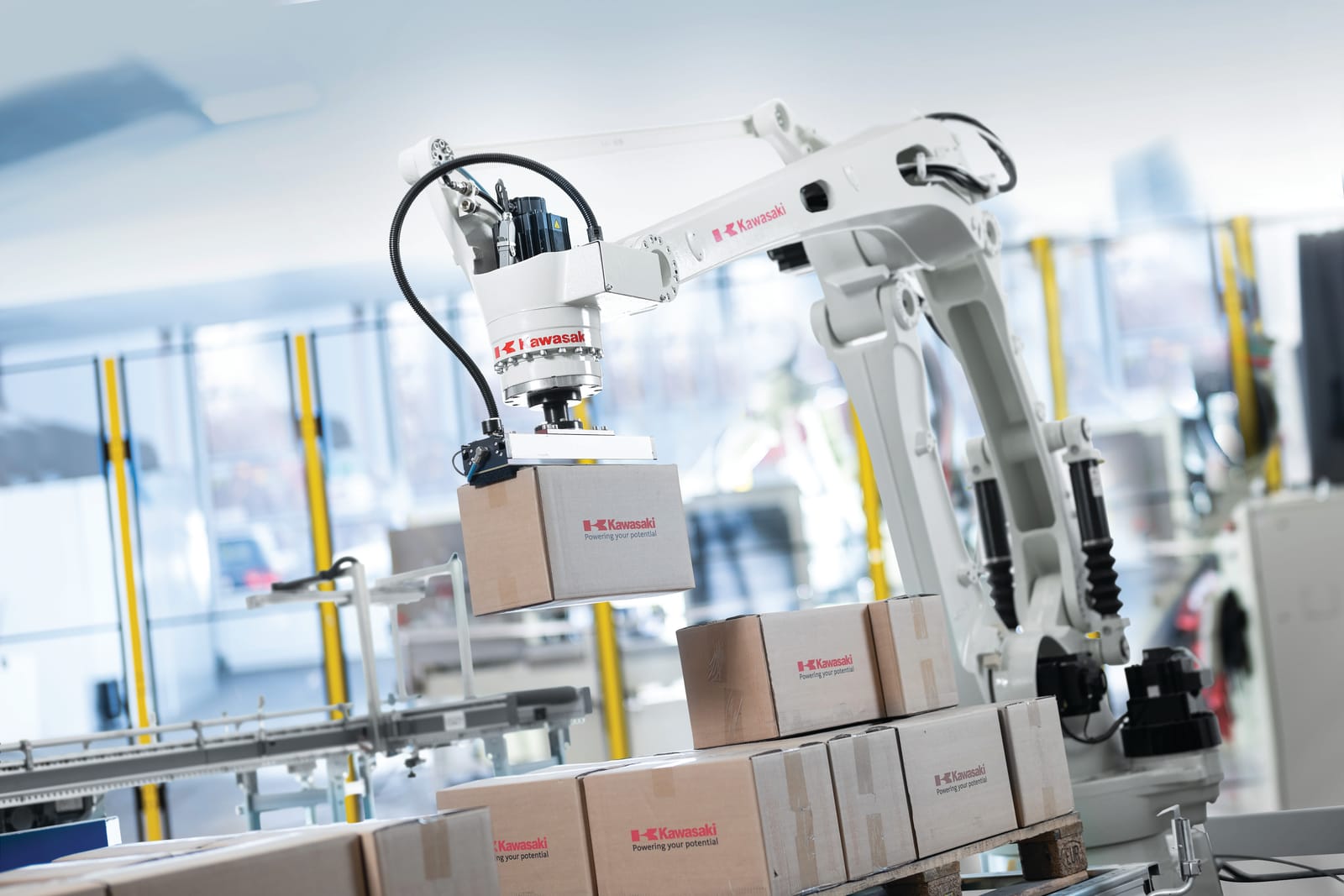 A Kawasaki palletizing robot stacking cases onto a pallet