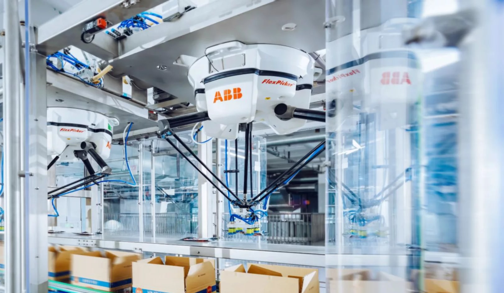 ABB IRB 360 FlexPicker robots picking product into cartons on a packing line