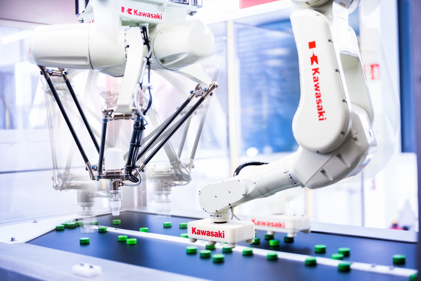 A Kawasaki delta robot and articulated arm picking product from a conveyor