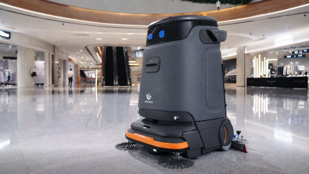 A KEENON KLEENBOT C55 floor cleaner working in a shopping mall atrium