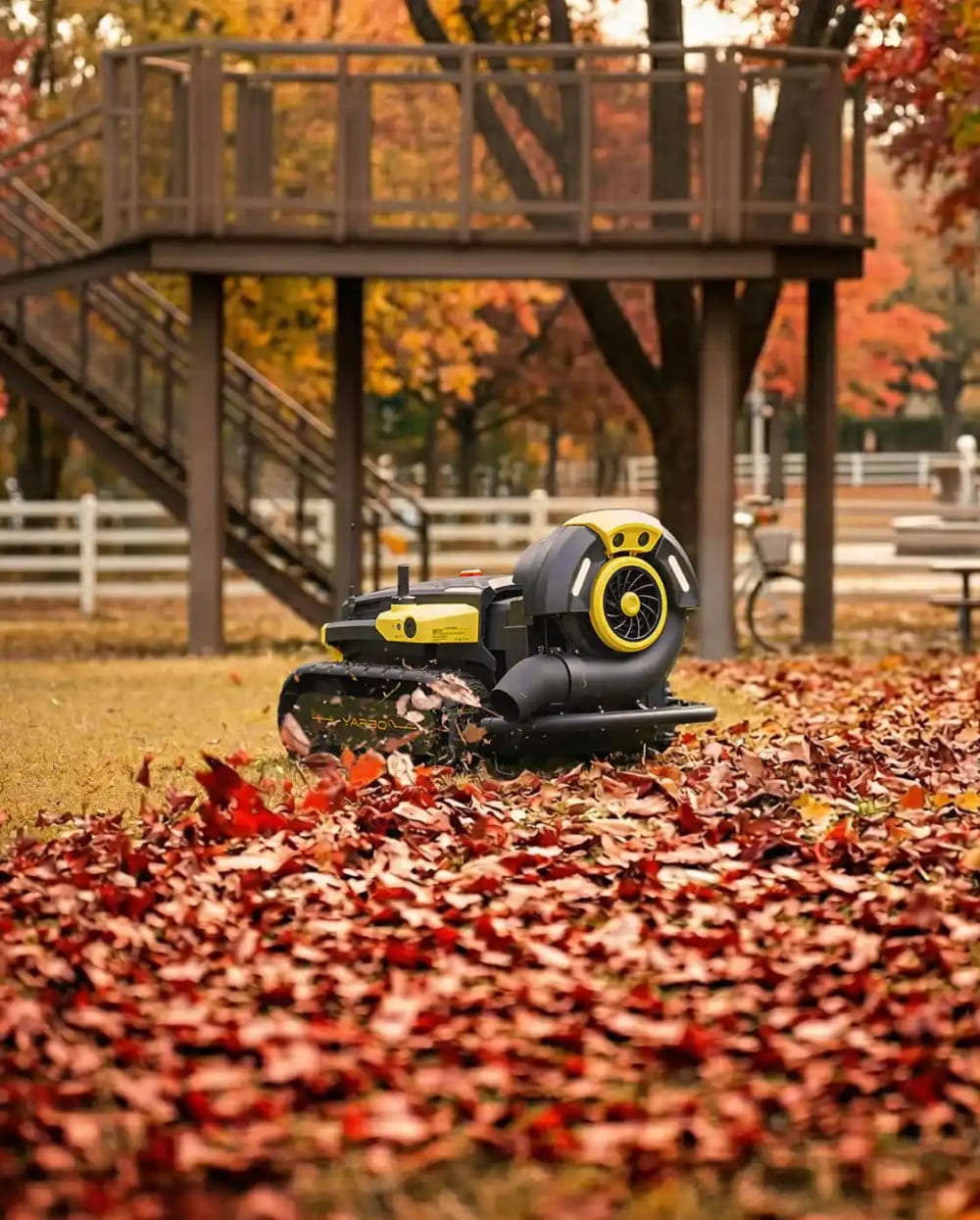 A Yarbo leaf blower clearing leaves from a yard